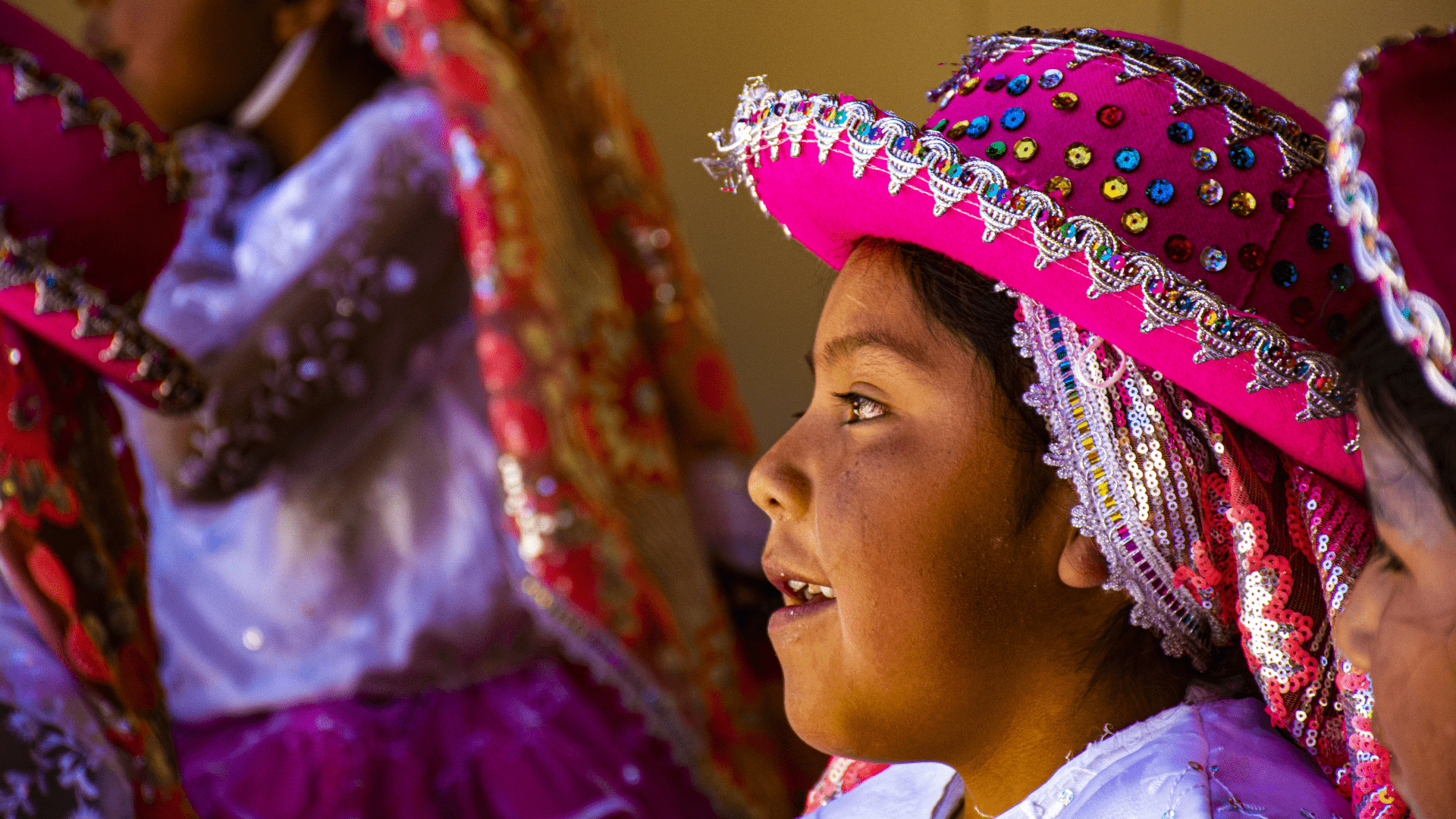 children in colorful attire during festivities at the Mirasol school